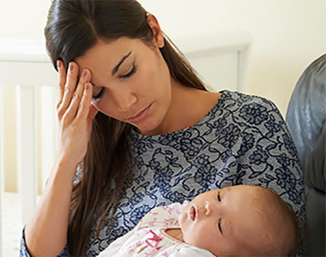 Mom holding baby with her hand on head